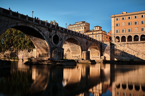 The smooth river Tiber under the Ponte Sisto bridge in Rome, Italy.