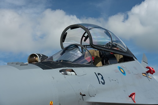 , Singapore: A closeup on the Maylasian Sukhoi SU27 flying in the blue cloudy sky