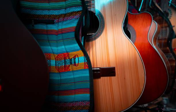 istock Row of various multi-colored acoustic guitars in a store 1432487848