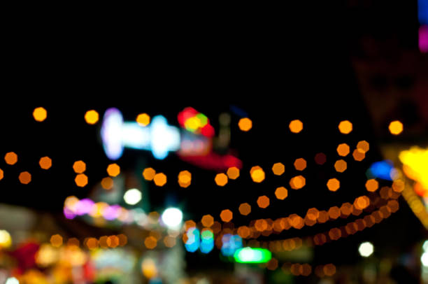 istock Abstract random colourful defocused blurred background pattern night life of local market 1432489342