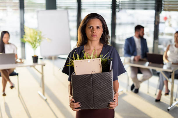 istock Depressed businesswoman leaving the office after being fired 1432490645