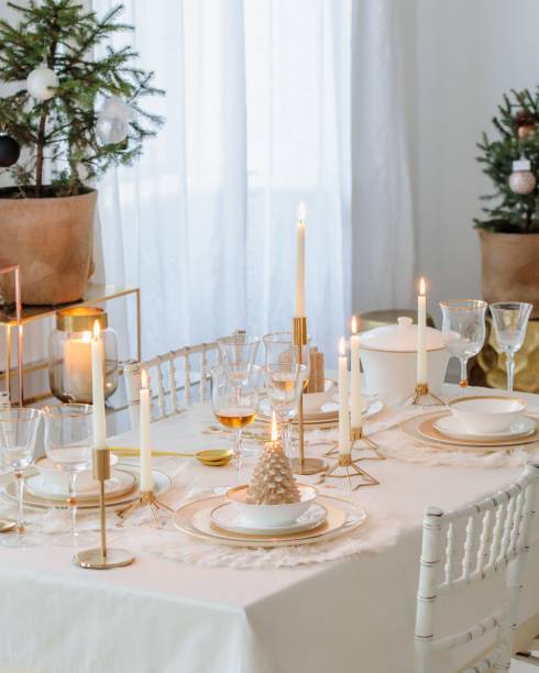 istock Dining table covered with white sheets and decorated with  plates, cups, and candles 1432491057