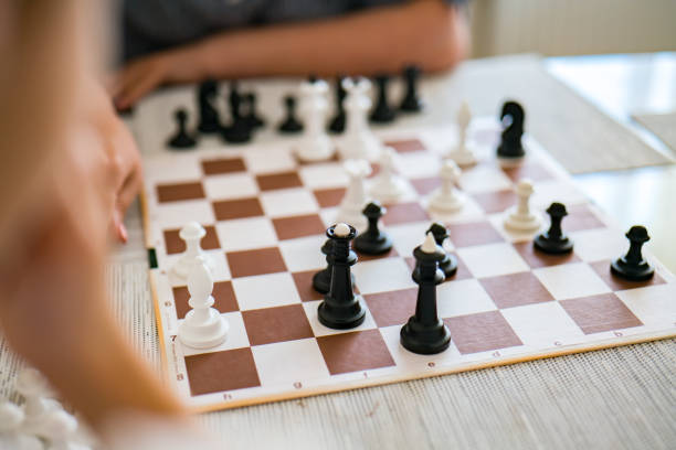 istock Chess pieces set on a chessboard. Peoples playing chess board. chess game 1432491139