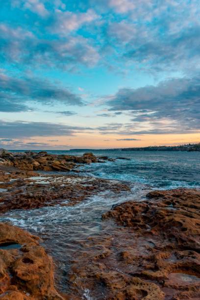 istock Vertical shot of sea waves hitting a rocky coast 1432492345