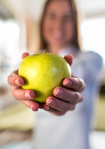 Close-up of a unrecognizable woman holding an apple