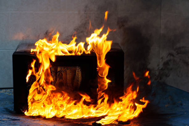 istock microwave oven on fire. the concept of fire in the kitchen. 1432494418