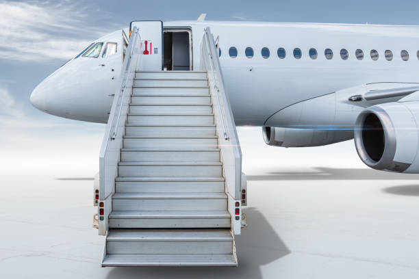istock White passenger jetliner with a staircase isolated on bright background with sky 1432495974