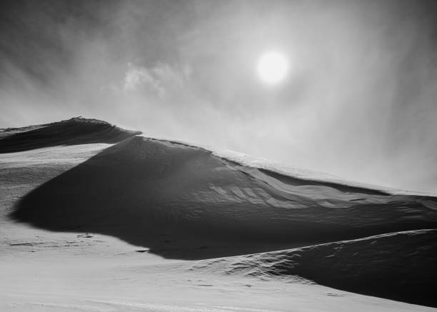 istock Grayscale shot of a white snow-covered mountain under a sunny sky 1432496949