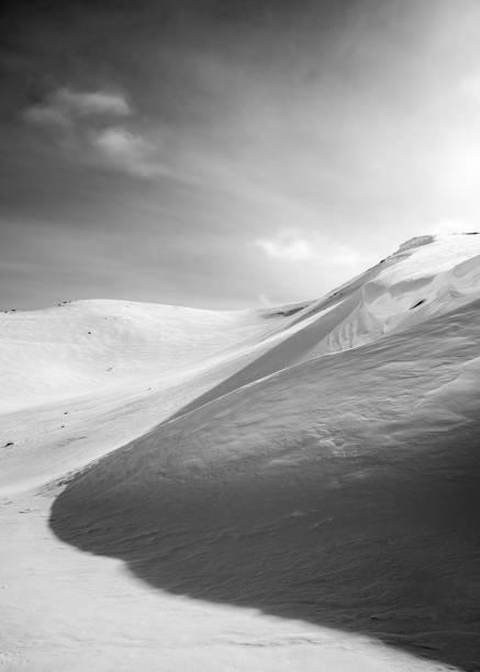 istock Vertical grayscale shot of a white snow-covered mountain under a sunny sky 1432496955