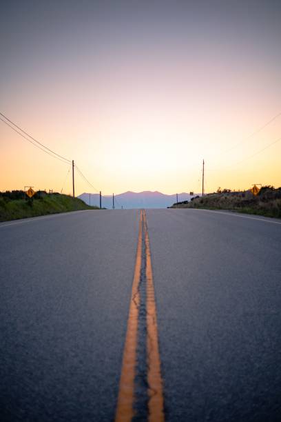 istock Vertical shot of a long road at sunset 1432497927
