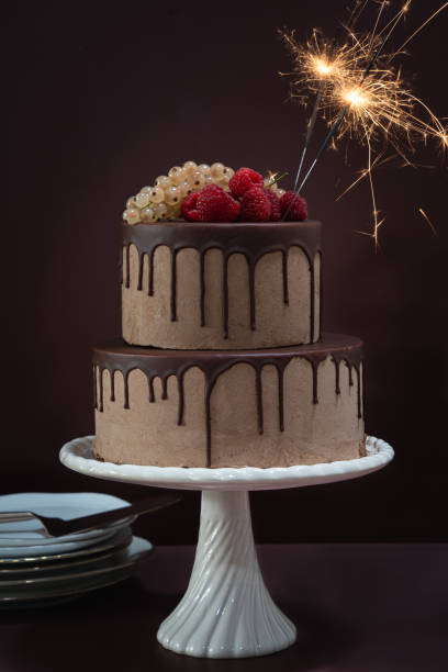 istock Celebration cake with sparkles on brown toned background 1432498088