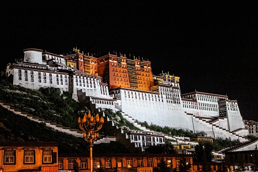 A beautiful view of the Tibetan Potala Palace in Lhasa, China at night, built in the dzong style of architecture