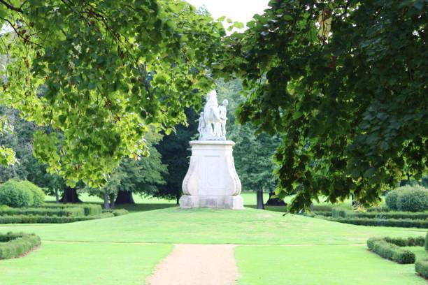 istock Pathway in a green park with tall trees 1432499107