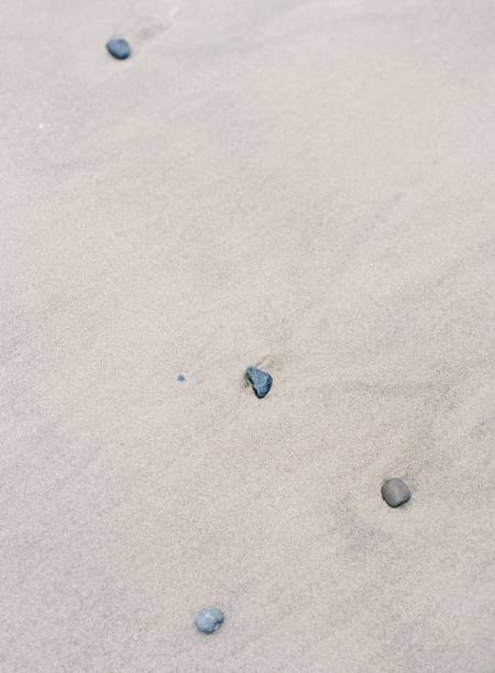 istock Vertical shot of the sand on the beach with rocks 1432501809