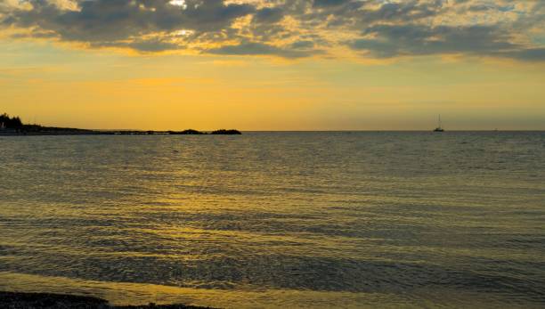istock Bright yellow sunset sky over a sea 1432502009