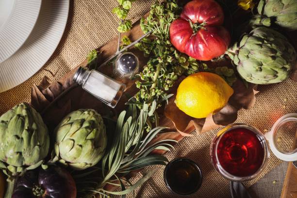 A cozy rustic kitchen table with autumn harvest and seasonings