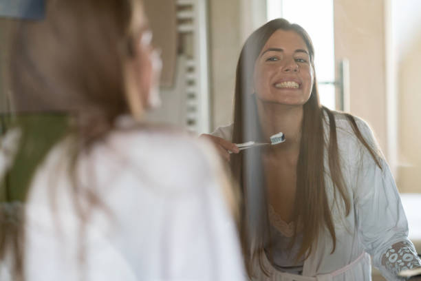 istock Woman is holding a toothbrush in a bathroom 1432502221