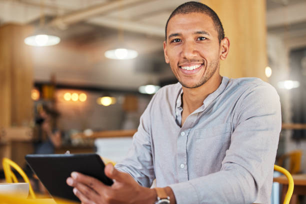 istock Freelancer entrepreneur or designer working online holding digital tablet, sitting in cafe or restaurant. Successful businessman with flexible schedule doing remote work on internet in coffee shop. 1432502869