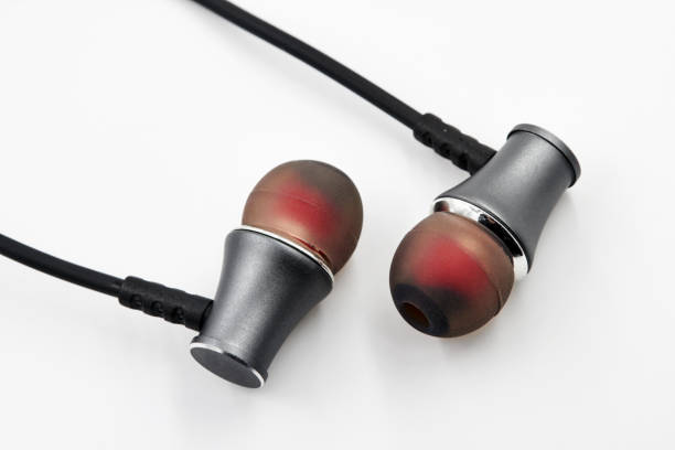 istock Black red earphones lie on white background. Closeup, selective focus 1432505012