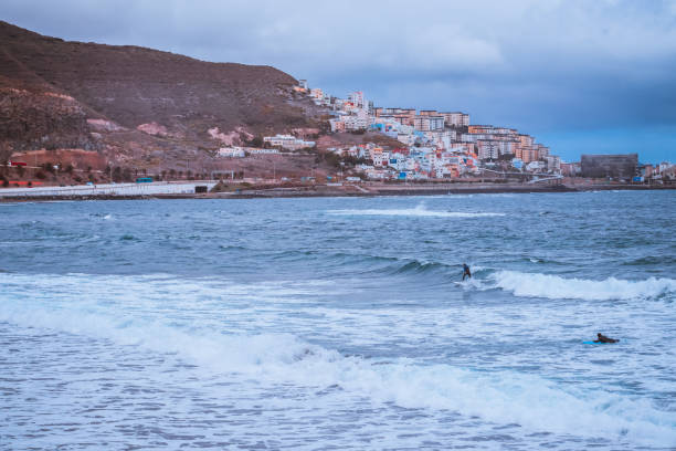 istock Surfer riding a board on the waves of the ocean 1432505309