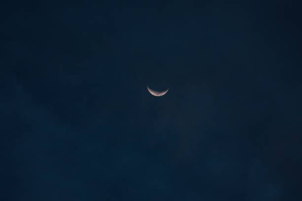 istock Beautiful crescent moon barely visible in a blue night sky 1432507171
