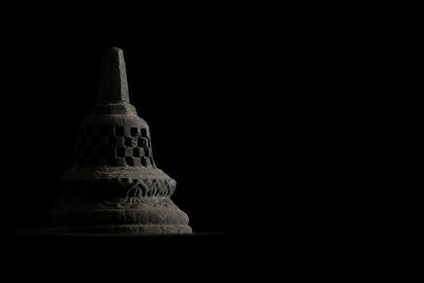 A miniature stupa made of temple stone with low key dramatic lighting