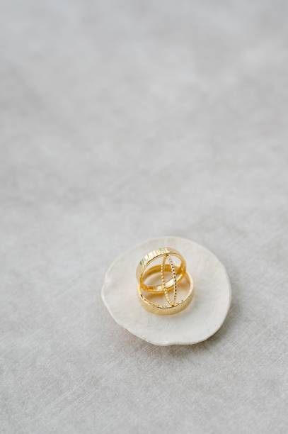 istock Vertical shot of golden wedding rings on a shell 1432508621