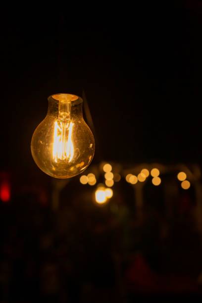 istock Vertical shot of the light bulbs in the dark 1432510712