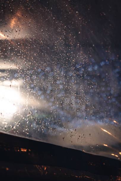istock Vertical closeup shot of a wet window with raindrops 1432511346