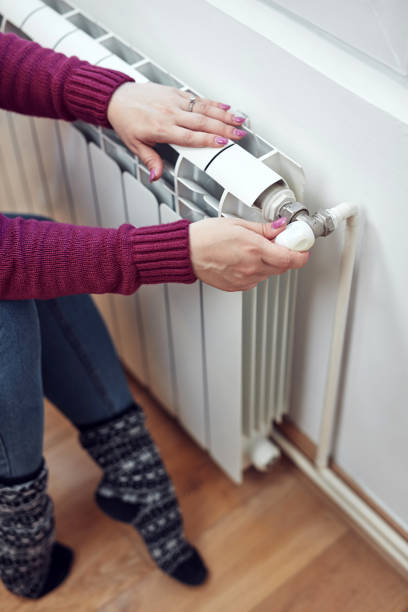 istock Woman heating on a chilly winter day, energy and gas crisis, cold room, heating problems. 1432511672