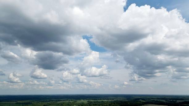 istock Drone view of a scenic cloudscape on a blue sky with green forests under 1432512264