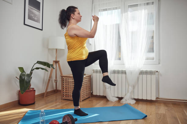 istock Woman training inside the living room, exercising at home. 1432512287