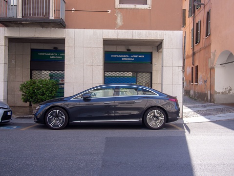 Cremona, Italy: A new EV electric Mercedes Benz EQE 350 plus parked on the street in Cremona, Italy