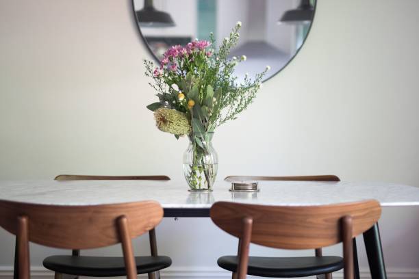 istock Decorative vase with a floral bouquet on an empty dining table 1432513377