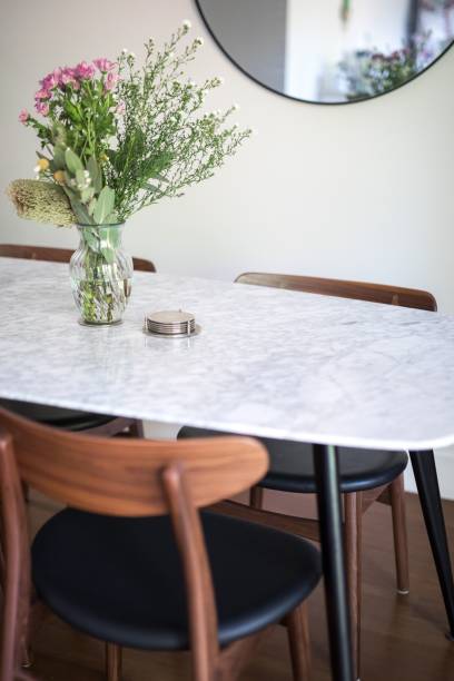 istock Vertical shot of a decorative vase with a floral bouquet on an empty dining table 1432513382