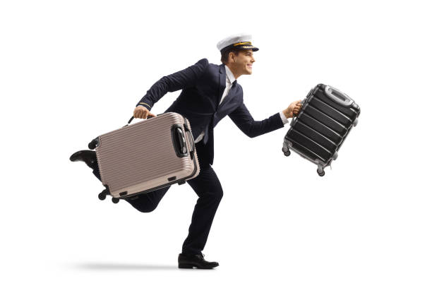 istock Full length profile shot of a pilot running with suitcases 1432514364