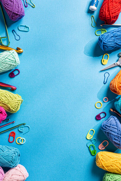 istock Crochet blue background with cotton yarn, crochet hooks and accessories. Flat lay overhead shot with copy space 1432514421