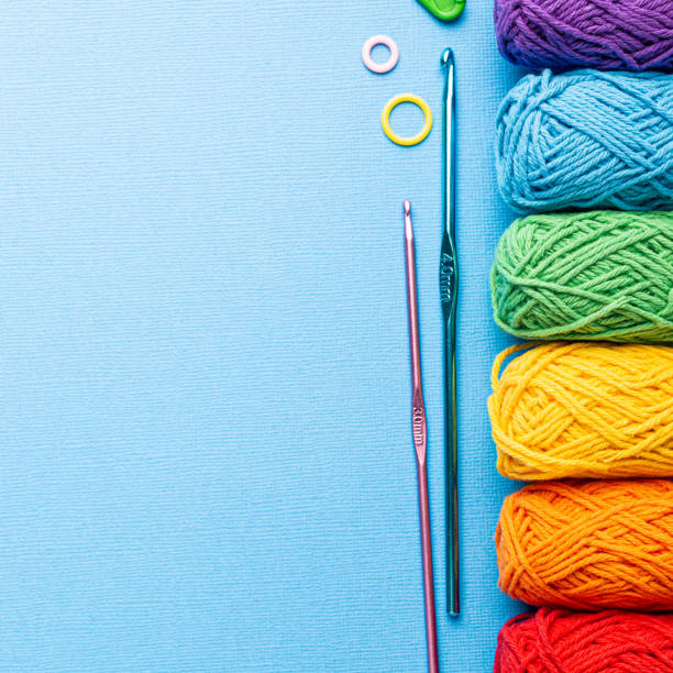 istock Crochet composition with cotton rainbow yarn, crochet hooks and accessories. Flat lay overhead shot with copy space 1432514429