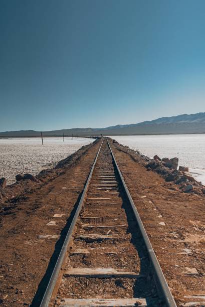 istock Railway of Tren a las Nubes going through snowy fields under blue sky.Vertical shot 1432515514