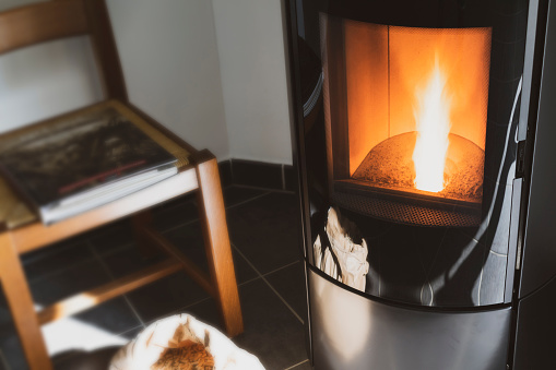 Modern domestic pellet stove, granules stove with flames
