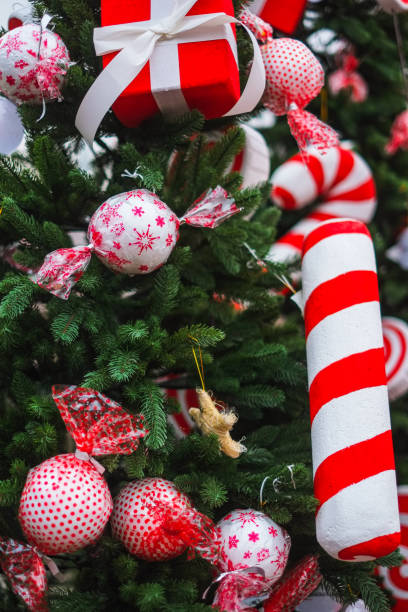 istock Red and white colored artificial candy canes and baubles on Christmas tree in the market 1432517515