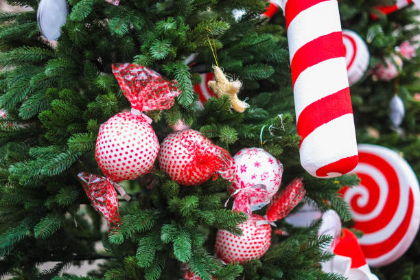 istock Red and white colored artificial candy baubles on Christmas tree in the market 1432517516