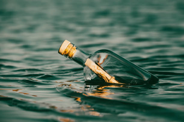 Message in a bottle floating on the ocean waves.