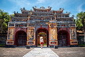 Young woman touring the interior of the ancient imperial city of Hue, Vietnam.