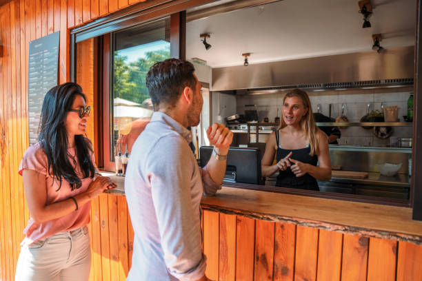 istock Caucasian Cashier Explaining Prices to Couple 1432518731