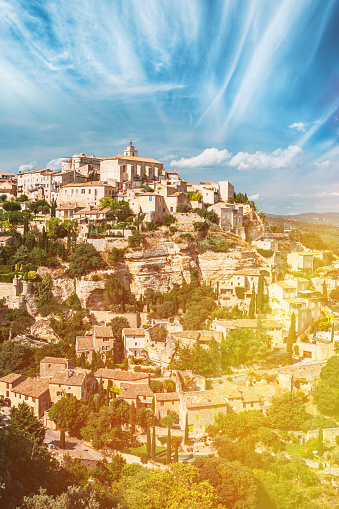 Sunshine sunlight Beautiful Scenic View Of Medieval Hilltop Village Of Gordes In Provence, France Scenic View Of Medieval Hilltop Village Of Gordes In Provence, France. Altered Sky.