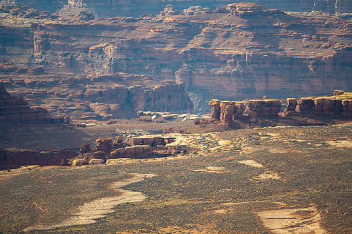 Aerial view overlooking The Maze containing deep canyons, plain deserts and mountain ranges in Canyonlands National Park, Utah, USA.