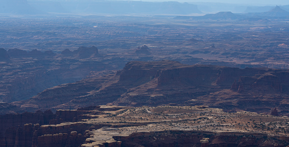 Aerial view overlooking The Maze containing deep canyons, plain deserts and mountain ranges in Canyonlands National Park, Utah, USA.