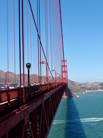 Side view of the Golden Gate Bridge with midday traffic