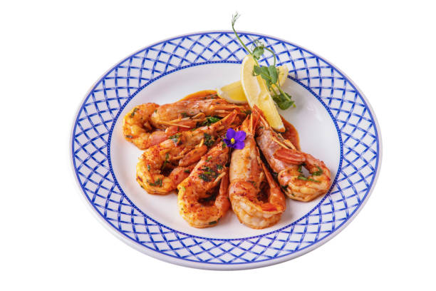 istock Fried shrimps with sauce, lemon, pea sprouts and violets in a plate on a white plate 1432523742